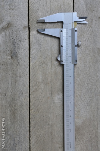 calipers on wooden background. copy space