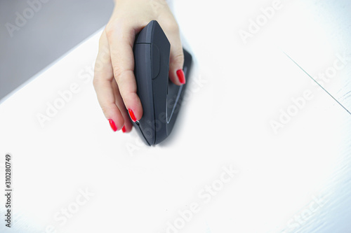 girl's hand uses a vertical ergonomic computer mouse joystick. photo