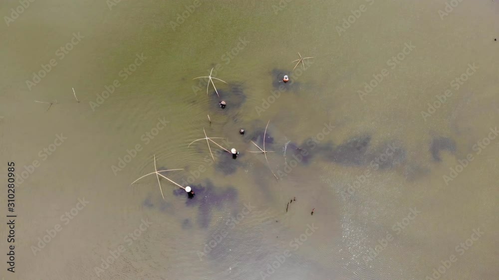Aerial view of fisherman with a fishing rod on the river bank. Man fisherman catches a fish. Concept of a rural getaway. Fishing in river. Aerial view of fisherman with a fishing rod on the river bank. Man fisherman catches a fish. Concept of a rural getaway. Fishing in river.