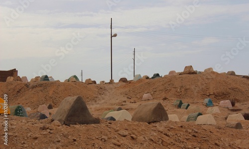 Cemetery in a village in Egypt with tombstones all around