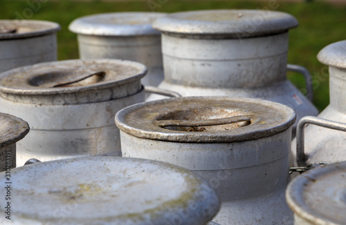 Lids of traditional milk churns at an old dairy farm.