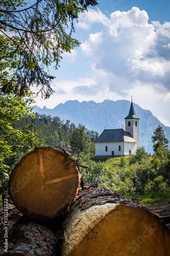 Church Cerkev Sveti Duh with mountain range Kamnik–Savinja Alps photo