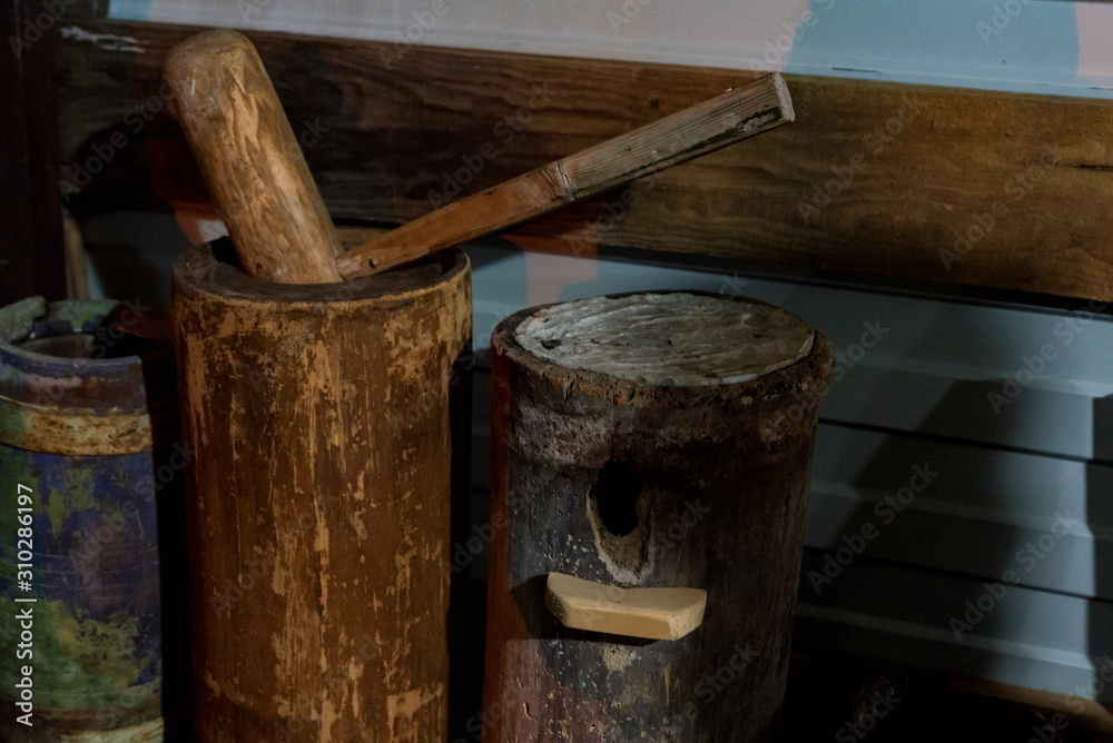 Close up old wooden bee hammer and bee-keepr's equipment Close up old wooden bee hammer and bee-keepr's equipment