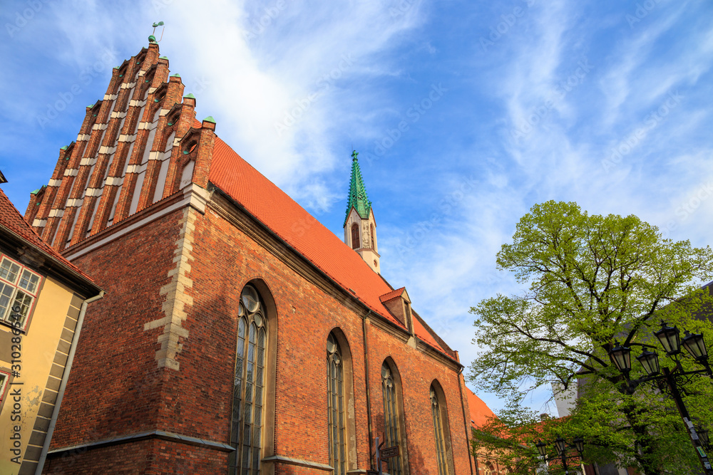 St. John's Church in Riga, Latvia, on a sunny day under a blue sky with an interesting pattern of high cirrus clouds.