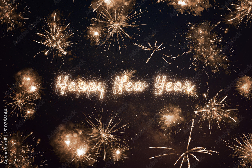 Happy New Year written with sparkle fireworks on night sky Stock Photo ...