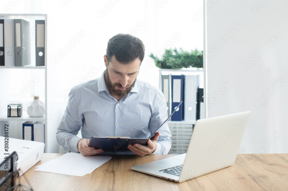 Bearded man working in the office. Bearded man working in the office.