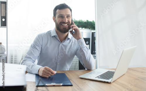 Bearded man working in the office.