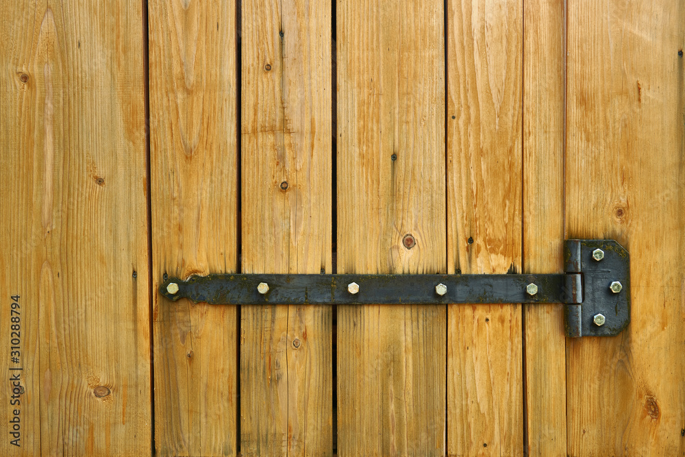 Iron latch and yellow wooden gate closeup on the ranch house for background or texture Iron latch and yellow wooden gate closeup on the ranch house for background or texture