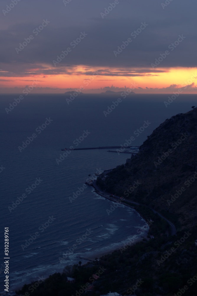 Dark, overcast sunset over the Mediterranean sea, in Terracina, Italy.