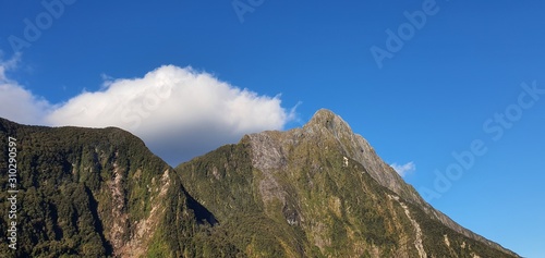 Milford Sound Fjord, Milford Sound / New Zealand - December 18, 2019: The Dramatic Mountains and Waterfalls of the Milford Sound Fjord, New Zealand photo