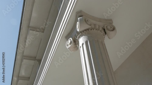 The building with white columns in antique style. Bottom view. Buildings and architecture.