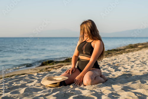 Cheerful plus size teenage girl enjoying the beach. smiling, happy, positive emotion, summer style.