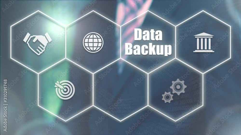 A businessman selecting a Data Backup concept on a futuristic computer display with a blue background A businessman selecting a Data Backup concept on a futuristic computer display with a blue background