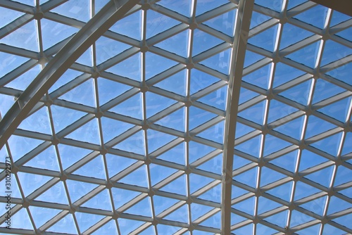 Large, modern design glass skylight at an airport. The beams form triangular patterns.