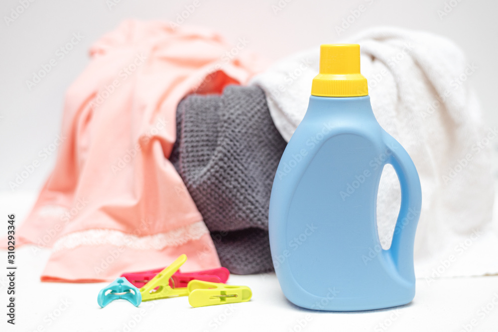 Detergent bottle, basin with dirty clothes on white background. Detergent bottle, basin with dirty clothes on white background.