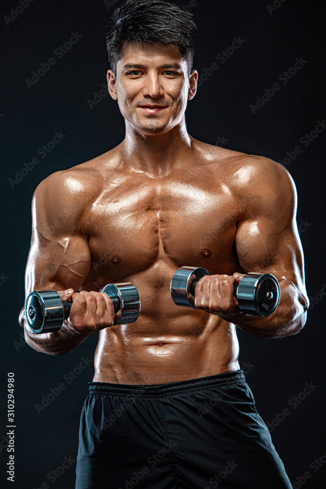 Athlete bodybuilder. Strong and fit man. Sporty muscular guy with dumbbells. Sport and fitness motivation. Individual sports recreation. Athlete bodybuilder. Strong and fit man. Sporty muscular guy with dumbbells. Sport and fitness motivation. Individual sports recreation.