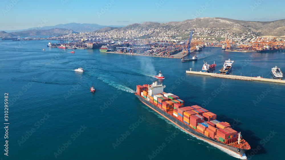 Aerial drone photo of container cargo carrier tanker leaving industrial port of Perama for Mediterranean destination, Attica, Greece