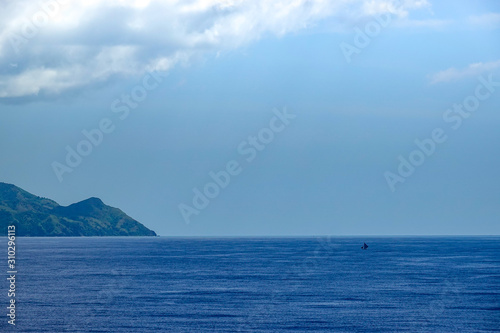 The hazy and mountainous coastline of the Caribbean Island of Haiti as a cruise ship sails by. © Joni