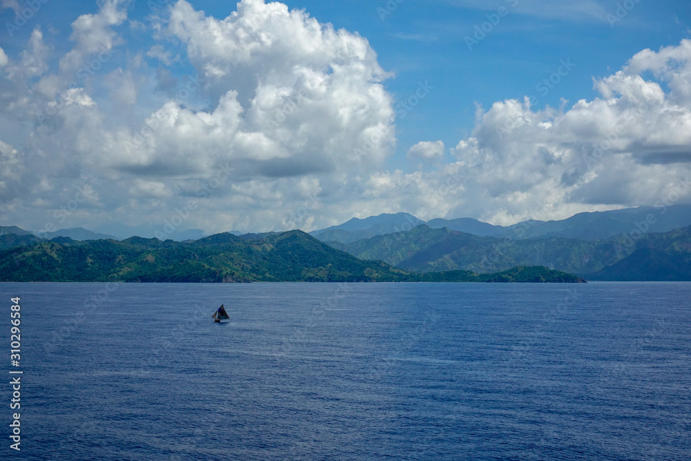 The hazy and mountainous coastline of the Caribbean Island of Haiti as a cruise ship sails by.