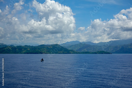 The hazy and mountainous coastline of the Caribbean Island of Haiti as a cruise ship sails by.