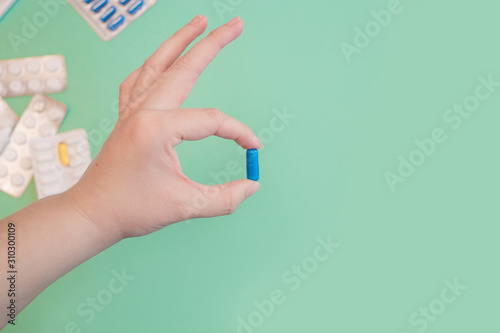 Vitamin pills and antibiotics on a colored background. Treating seasonal allergies, flu, and illness