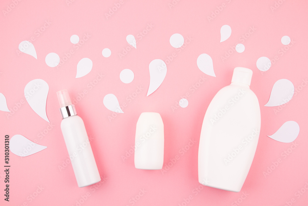 Cosmetic bottle on pastel modern paper background with paper cut splashes. Mock-up for product package branding