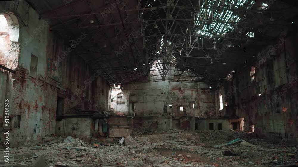 Moving inside ruined and abandoned large creepy industrial factory warehouse hangar