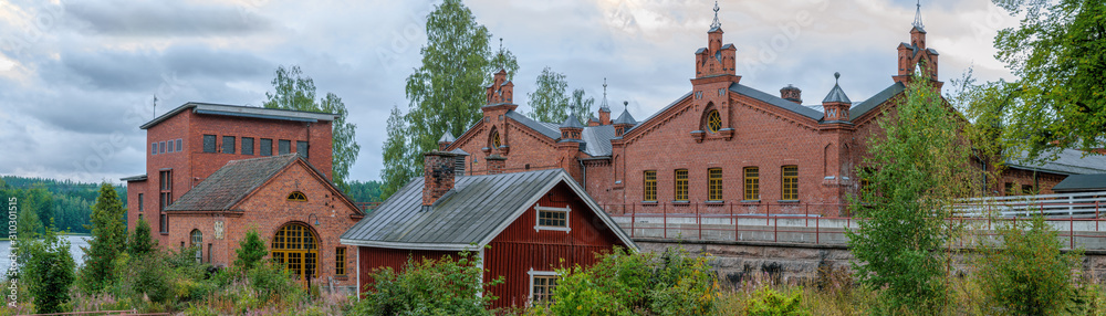 Panorama of old paper mill buildings of red brick at overcast autumn day. Verla Groundwood and Board Mill - Museum. Finland