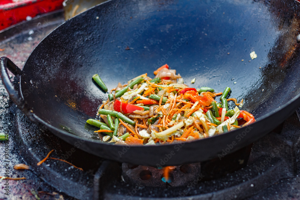 chef cooks Chinese noodle wok at street food festival chef cooks Chinese noodle wok at street food festival
