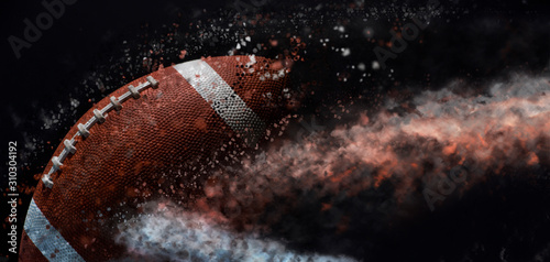 Canvas Print American football ball close up on black background.