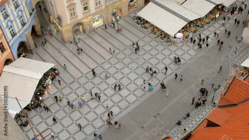 tourists are strolling in old town of Prague in daytime, top view from Old Town Hall photo