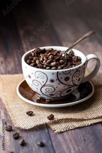 A cup full of coffee beans.