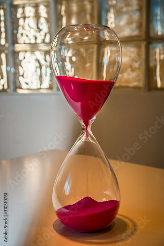 Hourglass on a white table in an office