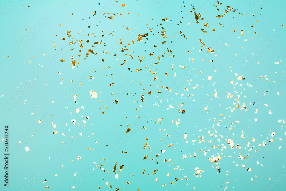 Golden flying sparkles on blue holiday background. Festive backdrop for your projects. - obrazy, fototapety, plakaty 