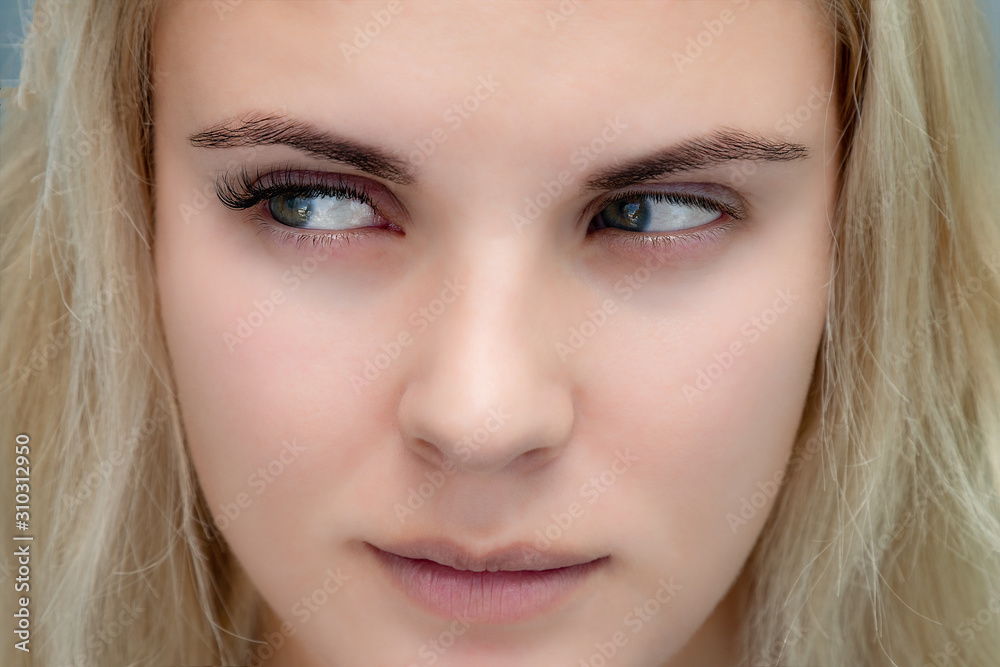 Eyelash extensions, natural volume, beautiful woman looking away to show the difference before and after procedure Eyelash extensions, natural volume, beautiful woman looking away to show the difference before and after procedure