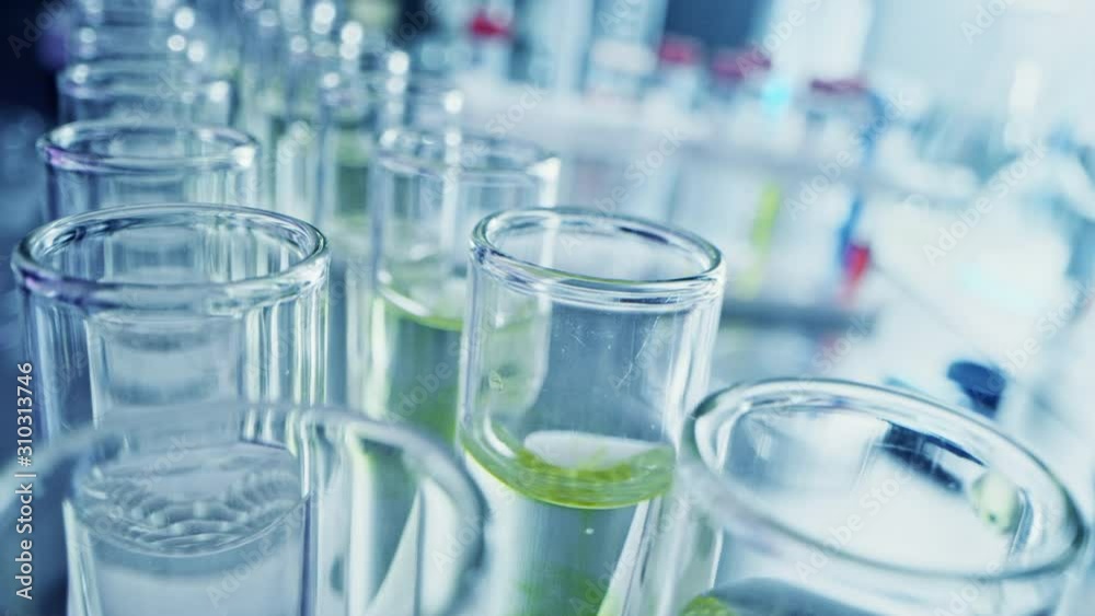 Pharmaceutics Laboratory: Multiple Pipettes Dropping Yellow Liquid into Test Tubes, Medical Research and Analysis. Product Line; Dropper Fills Sample Tubes for DNA Study. Close-up Macro