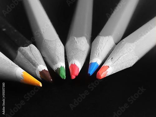 Grey photo of colored pencils on black background