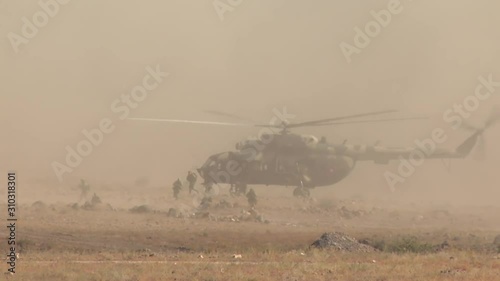 Military soldiers jump out of the helicopter
