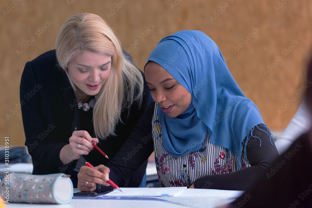 Female Architecture teacher at work. Female professor explain architectural projects to female african student. Female Architecture teacher at work. Female professor explain architectural projects to female african student.