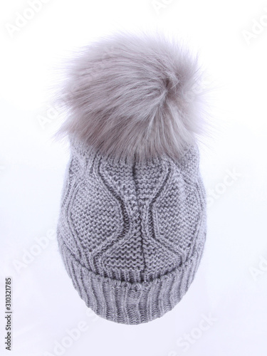 Beautiful luxury knitted hat with a gray fur on a white background