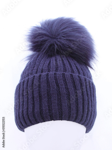 Dark blue knit wool hat with pompom isolated on white background