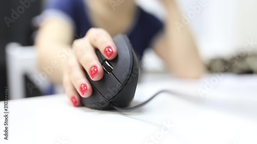 girl's hand uses a vertical ergonomic computer mouse joystick. photo