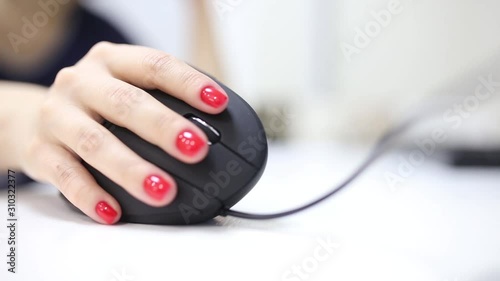 girl's hand uses a vertical ergonomic computer mouse joystick. photo