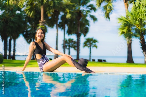 Portrait beautiful young asian women happy smile relax around swimming pool © siraphol