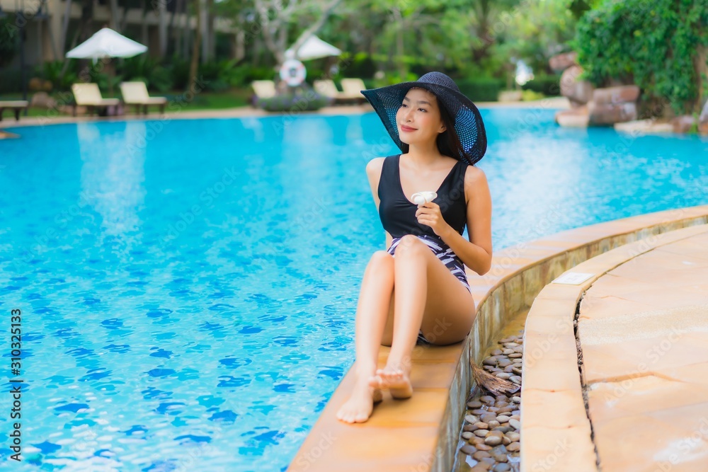 Portrait beautiful young asian women happy smile relax around swimming pool