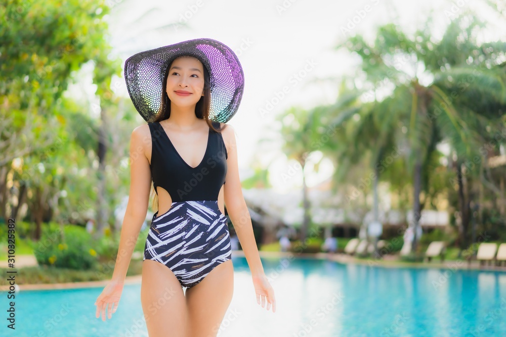 Portrait beautiful young asian women happy smile relax around swimming pool