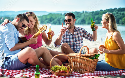 Group of friends having fun on the beach. Lifestyle, vacation concept