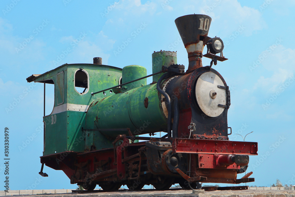 Fototapeta premium Unused old rusty antique green steam train locomotive