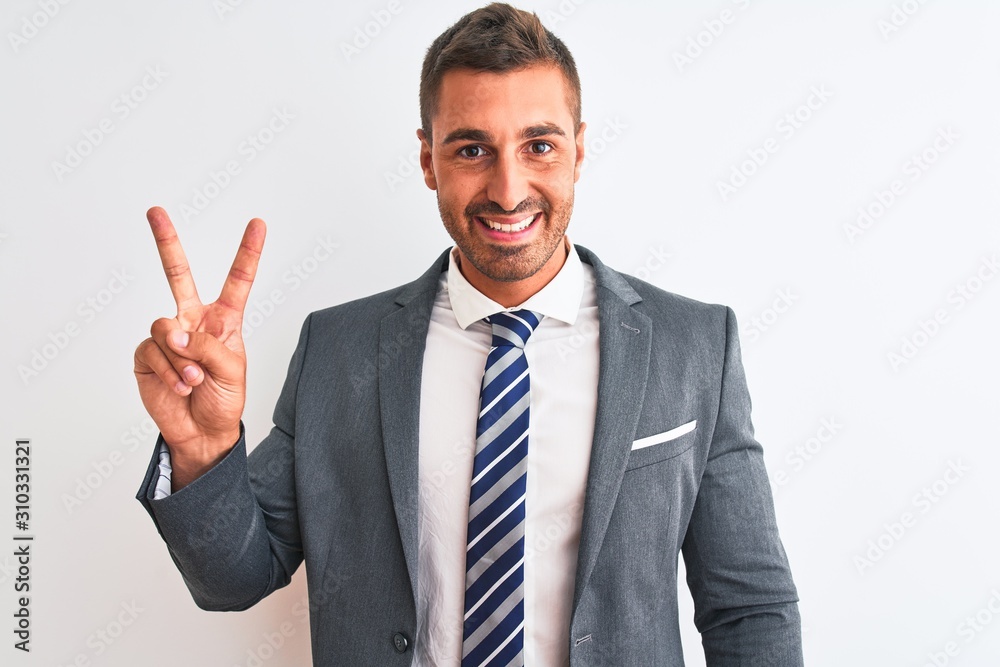 Young handsome business man wearing suit and tie over isolated background showing and pointing up with fingers number two while smiling confident and happy. Young handsome business man wearing suit and tie over isolated background showing and pointing up with fingers number two while smiling confident and happy.