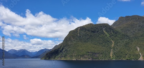 Doubtful Sound Fjord, Doubtful Sound / New Zealand - December 18, 2019: The Majestic Mountains and Waterfalls of the Doubtful Sound Fjord, New Zealand photo